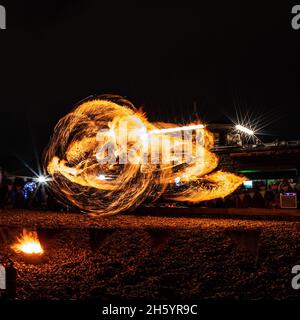 East Beach, Worthing, UK. 5 November 2021.  Fire performers on Worthing beach perform to a crowd before the main firework display  Worthing Lions Fireworks. . Picture by Julie Edwards./Alamy Live News Stock Photo