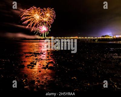 East Beach, Worthing, UK. 5 November 2021.  Fireworks are set off of Worthing Pier and reflect in the incoming tide  Worthing Lions Fireworks. . Picture by Julie Edwards./Alamy Live News Stock Photo