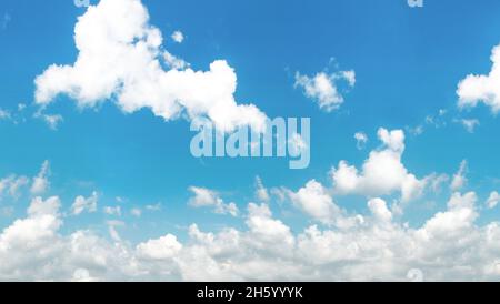 Blue and cyan gradient coloured sky and white clouds floating on air. Astonishing view of harmony of cumulus and clear sky. Stock Photo