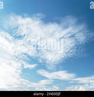 Blue and cyan gradient coloured sky and white clouds floating on air. Astonishing view of harmony of cumulus and clear sky. Stock Photo