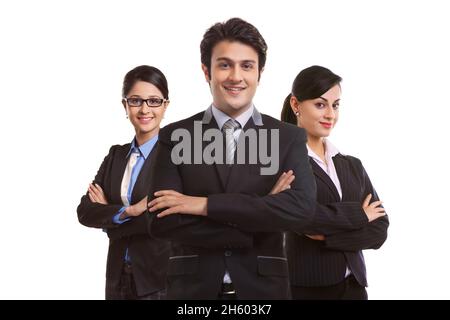 A team of corporate employees standing together with crossed arms in business suit. Stock Photo