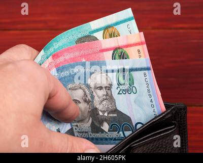 Dominican money - peso in the black wallet Stock Photo - Alamy