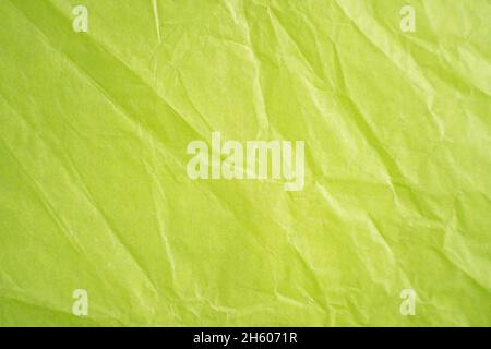 an empty wrinkled lime green tissue paper textured background Stock Photo
