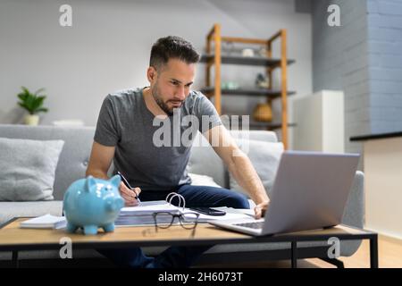 Budget And Finance Household Paperwork Using Calculator Phone App Stock Photo