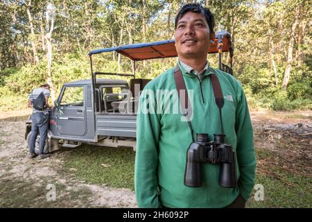 November 2017. Nature guide, Rajendra Chaudhary, became a guide six years ago after graduating with a humanities degree from university. He love being out in and learning about nature. Jeep safaris are replacing elephant safaris in Chitwan National Park and some of the community forests, catering to tourists more sensitive to animal rights issues or who are simply looking for a diferent experience. Kumrose Community Forest, Kumrose, Nepal. Stock Photo