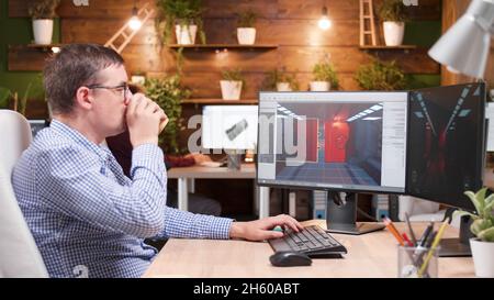 Game creator developing 3d videogame working at graphic ilustration in creative company office. Artist developer analyzing video game production using gaming software. Virtual environment on screen Stock Photo