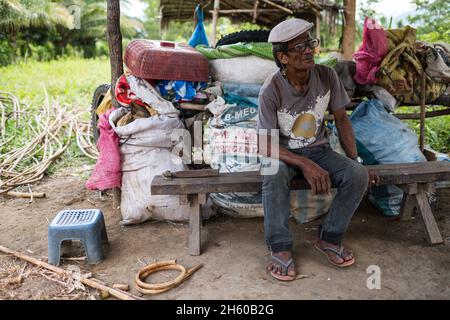 July 2017. Arenesto Deguen making an infant's walker from ratan. Local handicrafts like this add value over simply harvesting the ratan, but are difficult to market and capitalize on without a better distribution system. Aborlan, Barangay Sagpangan, Palawan, Philippines. Stock Photo