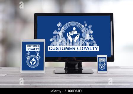 Customer loyalty concept shown on different information technology devices Stock Photo