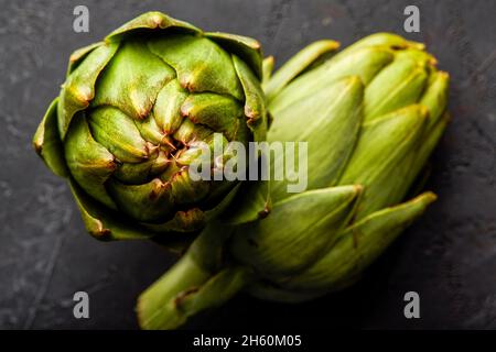 Artichokes on a black background. Stock Photo