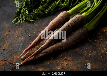 Bunch of carrots on a black background. Stock Photo