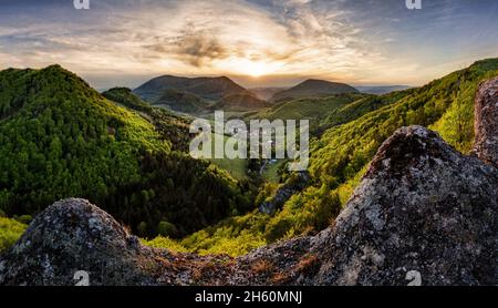 Rocks and forest landscape at dramatic sunset, spring time Stock Photo