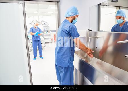 Doctor or nurse washing hands for disinfection and hygiene before the operation Stock Photo