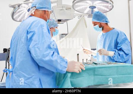 Surgery team performing an emergency operation on a patient in the operating room of a clinic Stock Photo