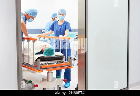 Doctor talks to patient in hospital bed before surgery in emergency surgery clinic Stock Photo