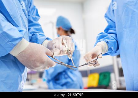 Surgeons hold various surgical instruments ready for an operation in the clinic Stock Photo