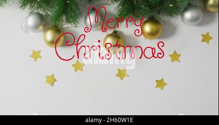 Image of stars falling over merry christmas text on white background Stock Photo