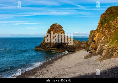 Blackchurch Rock on Mouth Mill beach in North Devon England UK a pyramidal stack of striated sandstone and mudstone. Stock Photo