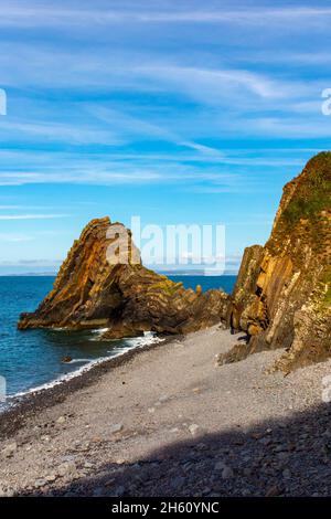 Blackchurch Rock on Mouth Mill beach in North Devon England UK a pyramidal stack of striated sandstone and mudstone. Stock Photo