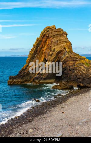 Blackchurch Rock on Mouth Mill beach in North Devon England UK a pyramidal stack of striated sandstone and mudstone. Stock Photo