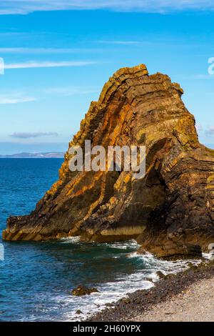 Blackchurch Rock on Mouth Mill beach in North Devon England UK a pyramidal stack of striated sandstone and mudstone. Stock Photo