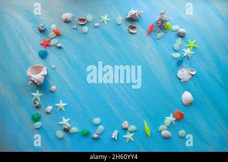 Seashells summer background. rectangular frame. Many different seashells, starfish on a background of turquoise paint strokes. Place for text. Stock Photo