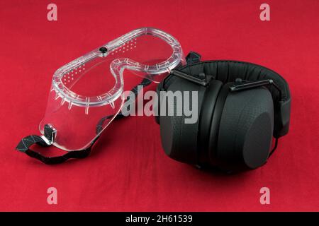 Hearing protection and safety goggles isolated on a red background Stock Photo