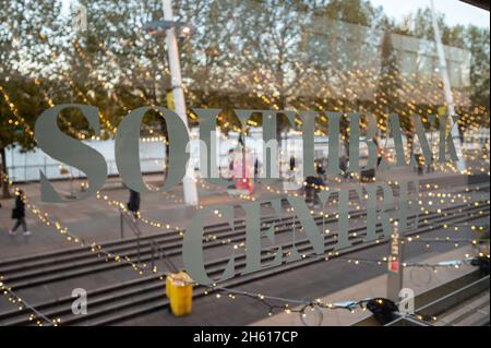LONDON - NOVEMBER 1, 2021: Sign for The Southbank Centre on glass with Christmas decorative lights out of focus in the background Stock Photo