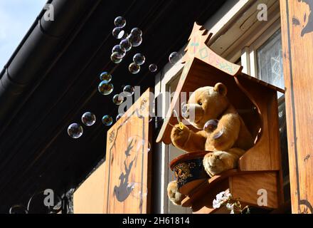 Toy Teddy bear blowing soap bubbles at Ribeauville village in Alsace region of France Stock Photo