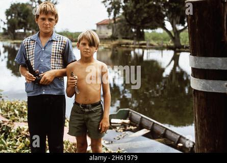 Boys with airgun and bird. These fisherman's sons live in Bayou Gauche, deep in the wetlands of Louisiana  ca. August 1972 Stock Photo