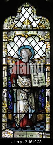 Stained glass window by Shrigley & Hunt depicting St John, St James Church, Harvington, Worcestershire Stock Photo