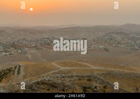 Sunrise view towards the Judaean desert and the Dead Sea, with a herd of sheep and Palestinian villages. From Herodium, the West Bank, South of Jerusa Stock Photo