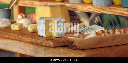 Cheese assortment served on wood table. Stock Photo