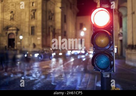 Red light on traffic lights against crosswalk. Night scene of city street in Prague, Czech Republic. Stock Photo