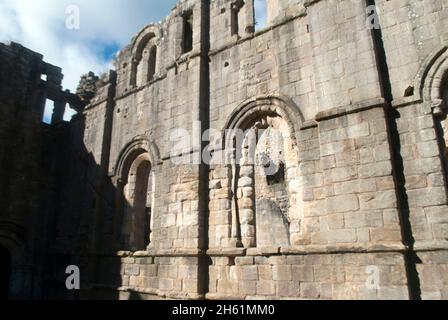 Stone wall with empty windows at of the Chapter House Fountains Abbey, Aldfield, near Ripon, North Yorkshire, England Stock Photo
