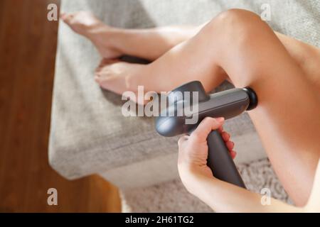 Massage of women's legs with a shock massage device. Shock self-massage to  restore fascia muscles and trigger points Stock Photo - Alamy