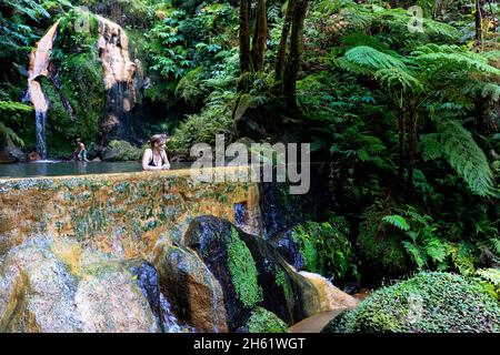 Woman bathing in beautiful thermal pools of Caldeira Velha, Sao Miguel, Azores, Portugal Stock Photo