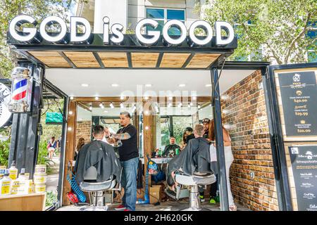 Florida Coral Gables,Miami,Carnaval Miami carnival pop up barbershop,The Spot,God is Good sign,Christian business Hispanic barber mobile, Stock Photo