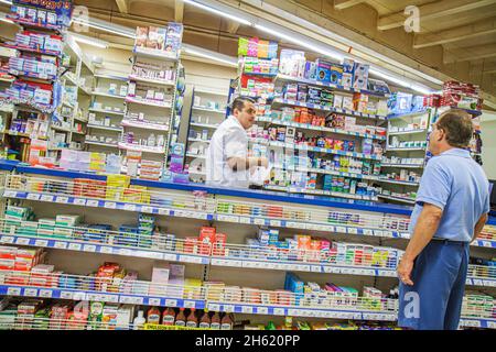 Cancun Mexico,Mexican,Avenida Tulum,Chedraui grocery store supermarket inside interior,pharmacy counter Hispanic man pharmacist customer Stock Photo