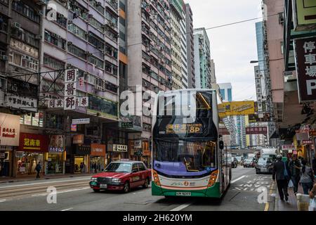 urban canyon and double decker buses in hong kong Stock Photo