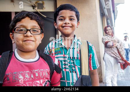 Dubai UAE,United Arab Emirates,Deira,Asian boys kids children students friends smiling Stock Photo