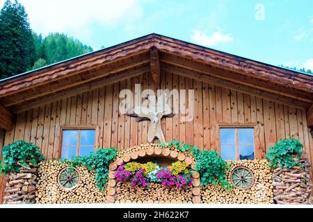 house,decorative,wood,flowers,floral decorations,cross,window,wooden house,navigation system,wipptal,tyrol,austria Stock Photo