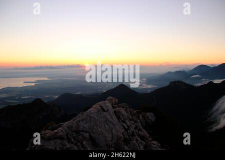 atmospheric sunrise during a hike to the summit of the kampenwand (1669 m) in chiemgau,chiemsee,chiemgau alps,near aschau,upper bavaria,bavaria,southern germany,germany Stock Photo