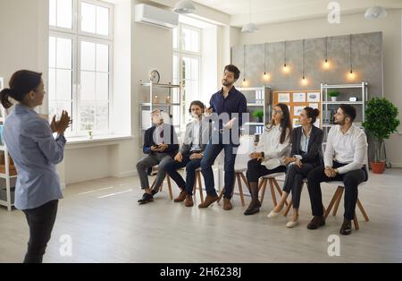 Group of business people having conversation with professional coach during workshop Stock Photo
