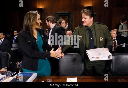 United States Border Patrol Chief Carla L. Provost introduces herself to co-witness Janice Ayala, Department of Homeland Security, as she prepares to deliver testimony on immigration policy before the Senate Judiciary Committee, Subcommittee on Border Security and Immigration, in Washington, D.C., Dec. 12, 2018. Stock Photo