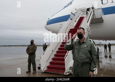 Reportage:  The commander of the 595th Command and Control Group and National Airborne Operations Center, Air Force Col. Brian D. Golden, salutes as Defense Secretary Dr. Mark Esper arrives to board an E-4B military aircraft for travel to New Delhi, India, from Joint Base Andrews, Md.,Oct. 25, 2020. Stock Photo