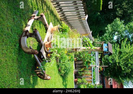 idyllic garden with sledge,decoration,horn sledge,herbs,herb garden,bird feeder,germany,bavaria,upper bavaria Stock Photo