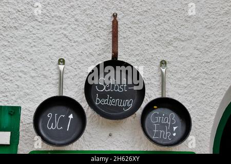 frying pans,pans on the house wall of the pfeishütte,1922 m goetheweg,toilet,self-service,greeting "griaß enk",excursion destination via innsbruck also accessible via scharnitz,gleirschtal,samertal,karwendel nature park,karwendel mountains,innsbruck,tyrol,austria,europe, Stock Photo