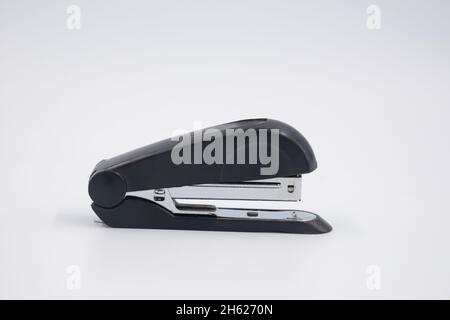 Black stapler isolated on white background. Device stapling for document. Stapling document sheet of finance, business, education. Stock Photo
