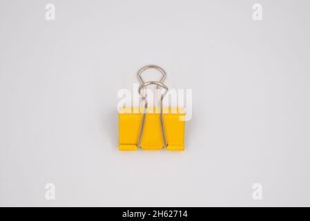 Yellow Paper clip isolated on white background. Stock Photo