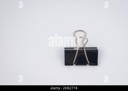 Black Paper clip isolated on white background. Stock Photo